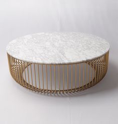 a white marble table with gold wire around the top and bottom, on a white background