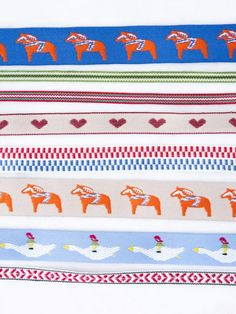 four different colored ribbons with horses and hearts on them, all lined up in rows