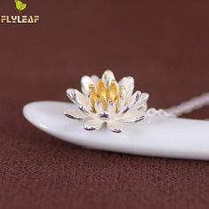 Silver necklace with blossoming lotus charm and gold design. Elegant Flower Pendant Necklace For Meditation, Spiritual White Flower Necklaces, Jewelry Pandora, Pendants For Women, Lotus Necklace, Clothes Jewelry, Silver Jewellery Indian, Rings Handmade, Flower Shorts