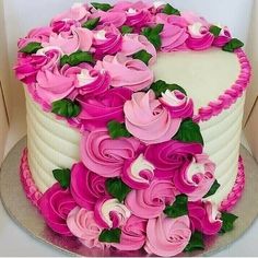 a white and pink cake with flowers on top