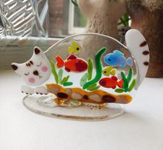 there is a glass figurine that has fish on it