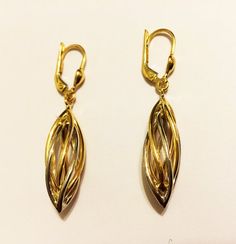 Fancy puffed rolling dangling earrings:- metal      : solid 10k two tone gold- weight   = 3 gr- length    = 1.50 "inch (42 mm)- thick      =  9 mm- clasp     : snap back- made     : in Italy Modern Gold Drop Earrings, Elegant Gold Linear Earrings With French Hook, Elegant Gold Earrings With Lever Back, Trendy Gold Earrings, Antique Locket, Gold Earrings For Women, Solid Gold Earrings, Earrings Metal, Evil Eye Pendant