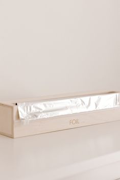 a white box with foil on it sitting on a counter