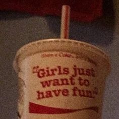 a paper cup with a straw sticking out of it's top and the words girls just want to have fun written on it