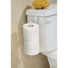 a white toilet sitting next to a yellow sponge