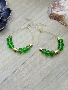 "Add a pop of color with these fun hoop earrings. *Faceted glass rondelle beads *Brass square beads *Ethiopian Elongated Brass Oval beads *Brass hoops *Brass ear hooks *Length measures 2.5\" *Created in studio - Wilmington, NC" Trendy Green Dangle Hoop Earrings, Green Teardrop Hoop Earrings For Everyday, Green Dangle Hoop Earrings Hypoallergenic, Green Teardrop Nickel Free Hoop Earrings, Nickel-free Green Teardrop Hoop Earrings, Green Teardrop Nickel-free Hoop Earrings, Everyday Green Teardrop Hoop Earrings, Green Teardrop Hoop Earrings For Jewelry Making, Green And Gold Earrings