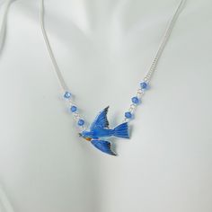 A vision in brilliant blue enamel with cobalt Swarovski stones on each side, this cloisonné and sterling silver Bluebird necklace is certain to charm and impress. The Bird hangs from a sterling chain that can be adjusted from 16 inches to 20 inches that culminates in another Swarovski bead at the end that dangles deliciously down your back when worn shorter. The Bird itself is 7/8 inch wide from beak to tail and has a wingspan of just over .75 inch. The necklace is in excellent, new condition and is marked 925 on the back. So very suitable for gift-giving, they'll certainly know you care! Blue Enamel Necklaces With Lobster Clasp, Nickel-free Blue Enamel Jewelry, Crystals Blue, Swarovski Beads, Swarovski Stones, Bird Jewelry, Austrian Crystal, Jewelry Bags, Blue Bird