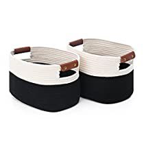 two black and white baskets with brown handles