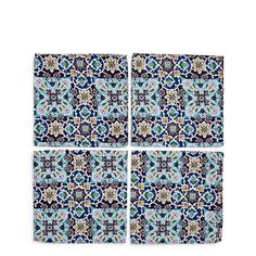 four pieces of blue and white tile with floral designs on them, all in different sizes