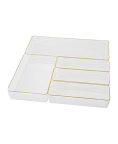 four clear plastic trays with gold trim