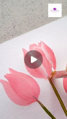 someone is painting pink flowers with watercolors on paper and using a pencil to draw them