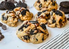 chocolate chip cookies with oreo chips on top and an oreo cookie in the middle