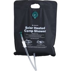 the solar heated camp shower bag is attached to a white pole and holds a toothbrush