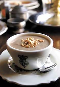 there is a bowl of soup on a saucer