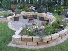 a circular garden with flowers and rocks around it