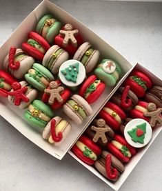 two boxes filled with different types of decorated cookies