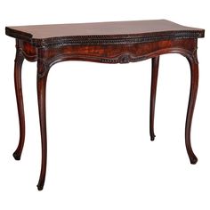 a wooden table with an ornate design on it's top and bottom edge, against a white background