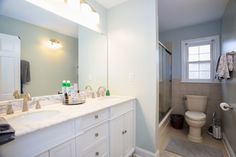 a bathroom with a sink, toilet and shower in it's own home area