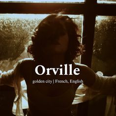 a woman standing in front of a window with the words orvillee written on it