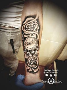 a man's arm with a clock and roses on it