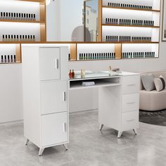 a white desk with two drawers and a mirror on the wall behind it in a salon