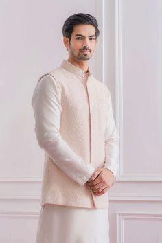 Editor's Note Featuring A Traditional Lucknowi Powder Pink Nehru Jacket With Delicate Thread And Sequence Embroidery And Minimal Details. Perfect For An Outdoor Occcasion. This Comes With A Tonal Plain Ivory Cotton Silk Kurta And Churidaar. Color: Pink Fabric: Cotton And Cotton Silk Care: Dry Clean Only About the Designer Ankit V Kapoor is a clothing brand that amalgamates traditional Indian handicrafts and bespoke tailoring. Inspired by the heritage of India and unified with revolutionary thoug Kurta Pajama With Nehru Jacket, Pose Men, Dad Outfits, Wedding Kurta For Men, Short Jackets, Wedding Motifs