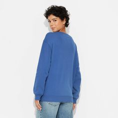 The Women's Bluey and Bingo Graphic Sweatshirt – Blue is a perfect leisure wear addition to your wardrobe. It features Bluey graphics on the front and comes with a classic crew neck and long sleeves. Made of lightweight fabric, you can comfortably run errands or lounge around all day. This sweatshirt can be easily cared for with an easy-care machine wash and tumble dry. Blue Casual Sweater With Relaxed Fit, Blue Crew Neck Top For Fall, Blue Sweatshirt For Fall, Blue Long Sleeve Sweatshirt For Loungewear, Blue Tops With Ribbed Cuffs And Relaxed Fit, Blue Relaxed Fit Sweatshirt, Blue Relaxed Fit Sweater For Loungewear, Blue Cotton Crew Neck Sweater, Casual Blue Tops With Ribbed Cuffs