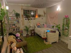 a living room filled with lots of furniture and plants on the walls, along with bookshelves