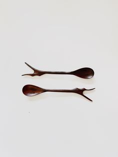 two wooden spoons sitting next to each other