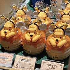 winnie the pooh honey pots are on display at a store in china, with price tags