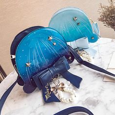 Elevate your Soft Girl Aesthetic with our Starry Milky Way Jellyfish Shoulder Bag. Free shipping in the US and worldwide. Length: 20 cm (7.87 inches); Height: 18 cm (7.09 inches); Width: 7 cm (2.76 inches). Crafted from high-quality patent leather, this shoulder bag exudes elegance and charm. Adorned with a mesmerizing design of jellyfish floating amidst a starry Milky Way backdrop, it's a true statement piece that will capture attention wherever you go. The high-quality patent leather material ensures durability and adds a luxurious touch to the bag. Featuring a unique design with stars and pearl chain and bow embellishments, this bag adds a whimsical and dreamy vibe to your outfit. The spacious interior offers ample room to carry your essentials, making it practical for everyday use. Com Kawaii Bags, Inspired Handbags, Soft Girl Aesthetic, Sweet Lolita, Cute Bags, Pearl Chain, Gothic Lolita, Soft Girl, Lolita Fashion