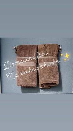 two brown towels hanging on the side of a wall next to a window with yellow stars