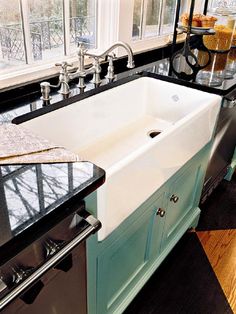 a white sink sitting under a window in a kitchen