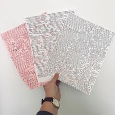 a person holding three pieces of paper in their hands with words written on them, all over the page