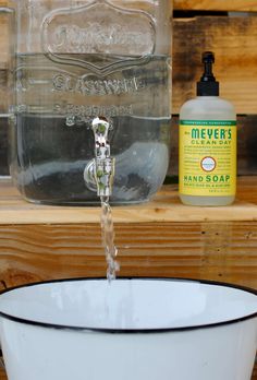 a water faucet is being used as a soap dispenser in front of a mason jar