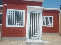 a red house with white doors and windows