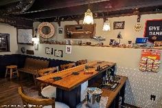 the interior of a restaurant with wooden tables and chairs, wood flooring and pictures on the wall