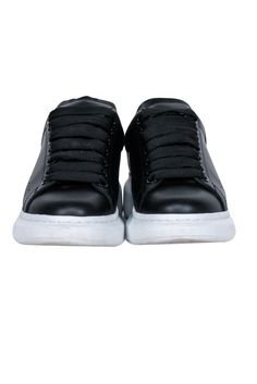 Elevate your fashion with Alexander McQueen's awesome black leather lace up sneakers. Great for a Sunday brunch with the squad, or a laid-back evening out, pair these kicks with your go-to denim and tee, or rock a playful frock. Size 6.5 (IT 36.5) Made in Italy Leather upper and lining Rubber sole Lace-up front Toe to heel 10.5" Back platform 1.75" Black Synthetic Lace-up Shoes With Textured Sole, Black Custom Sneakers With Textured Sole, Custom Leather Low-top Sneakers With Elastic Laces, Leather Sneakers With Elastic Laces, Leather Lace-up Sneakers With Elastic Laces, Black Sporty Lace-up Shoes With Rubber Sole, Custom Leather Lace-up Sneakers With Elastic Laces, Leather Low-top Lace-up Shoes With Elastic Laces, High-top Lace-up Shoes With Contrast Sole For Streetwear