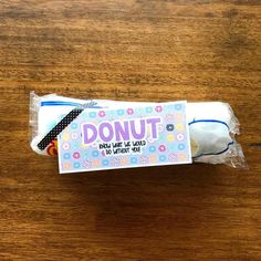 a package of donut wrapper sitting on top of a wooden table next to a toothbrush