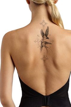 a woman with a bird tattoo on her back