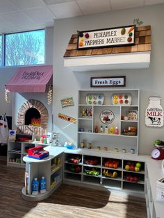 the inside of a children's playroom with toys and food on display in it