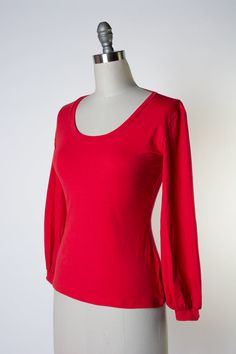 Introducing the Grace Top, a timelessly chic cotton knit piece with a scoopy neck and bishop sleeve, for a versatile wardrobe addition. Crafted from soft, durable fabric, this top offers exemplary comfort and all-day wearability. Plus, its classic color ensures you can style the Grace Top in a variety of ways. Jersey Knit - 95Cotton/5Spandex blend Scoopy Neckine Bishop Sleeve Fitted Long Sleeve Top In Solid Color, Stretch Puff Sleeve Solid Color Top, Solid Color Stretch Puff Sleeve Top, Stretch Solid Color Puff Sleeve Top, Fall Red Elastane Tops, Everyday Solid Color Stretch Long Sleeve Top, Stretch Long Sleeve Scoop Neck Top In Solid Color, Solid Color Stretch Long Sleeve Top With Scoop Neck, Solid Stretch Long Sleeve Top With Scoop Neck