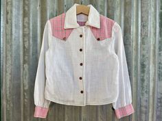 Adorable vintage 90's kids western shirt.  Made from a lightweight white fabric (very slightly sheer), with contrast yokes and sleeve cuffs in a fun hot pink and green check. The shirt has long sleeves, a turn down collar and metallic snap buttons. Size Small. (Approx age 6-7 ) Measurements: Chest: 68.5 cm / 27 inches Shoulder: 29.5 cm / 11.5 inches Length: 39.5 cm / 15.5 inches Sleeve: 40.5 cm / 16 inches This item is one of a kind. BUYING VINTAGE: While all care is taken to state any obvious faults, please note that when you buy a vintage or preloved item, they may show small signs of ageing, wear and/or repair. Please note that if you are ordering from anywhere outside of Australia please add your phone number as it is now required for delivery.  Thanks much. Visit my website   https:// Collared Shirt For Rodeo In Spring, White Shirt For Rodeo In Spring, White Western Shirt For Spring, White Western Style Shirt For Spring, Western Style White Shirt For Spring, Western White Tops For Spring, White Western Button-up Top, Retro Button-up Top For Ranch, Vintage Collared Tops For Rodeo