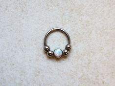 "Silver Septum Clicker or Daith Earring Ring with White Opal 📯 SPECIAL OFFER: If you buy this White Opal septum ring, together with either Blue or Purple, you will get 3rd one as a gift! 🎁 Blue: https://www.etsy.com/listing/793235153/silver-septum-clicker-daith-earring-ring Purple: https://www.etsy.com/listing/794876351/silver-septum-clicker-ring-daith-earring HOW YOU CAN WEAR IT? ❖ daith captive bead ring ❖ septum captive bead ring ❖ septum horseshoe ❖ septum retainer DIMENSIONS ❖ 16 gauge (1 Nickel-free White Gold Septum Ring As A Gift, Nickel-free White Gold Septum Ring Gift, White Gold Nickel-free Septum Ring Gift, Round Septum Ring Gift, Spiritual Round Septum Ring Gift, Spiritual Style Septum Ring Gift, Spiritual Gift Septum Ring, Nickel Free Round Septum Ring As Gift, Nickel-free Round Septum Ring As Gift