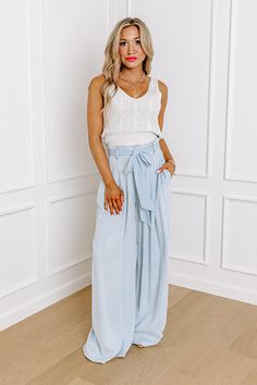 - Go with this flow in these trendy pants! - Unlined chambray material - A waistline with an elastic back, belt loops, and a removable tie closure belt - Pleated details on front - Functional side pockets - A relaxed silhouette that ends in wide floor length hemlines Trendy Belted Bottoms In Medium Wash, Trendy Belted Medium Wash Bottoms, Trendy Medium Wash Belted Bottoms, Belted Denim Blue Bottoms In Denim, Casual Belted Bottoms In Denim Blue, Belted Denim Blue Bottoms, Chic Belted Denim Blue Bottoms, Casual Denim Blue Belted Bottoms, High Waist Belted Denim Bottoms