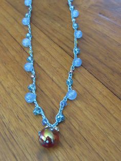 Orange Glass Bead crotched on blue metallic thread with blue quartz beads and crystals.  This is a fun necklace to be worn by someone who is fun and lively!  Or someone who is carefree or wants to feel happy.  The necklace is unique and is fun for these summer days.  It will look great with jeans and a t-shirt or at night with a simple dress. Necklace style reminds me of the beach. Adjustable Blue Wire Wrapped Crystal Necklace, Blue Bohemian Crystal Necklaces For Party, Blue Bohemian Crystal Necklace For Party, Bohemian Blue Crystal Party Necklace, Unique Blue Beaded Necklace With Dangling Beads, Unique Adjustable Blue Crystal Necklaces, Adjustable Blue Crystal Necklaces For Festivals, Adjustable Blue Crystal Necklace For Festival, Dress Necklace