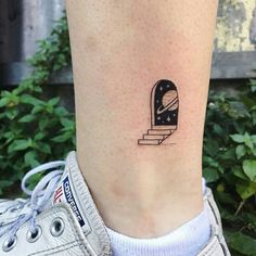 a woman's foot with a small tattoo on the side of her leg that reads interest