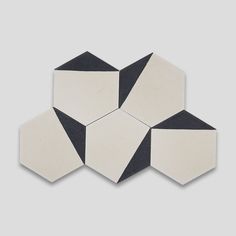 four black and white hexagonal tiles on a gray background