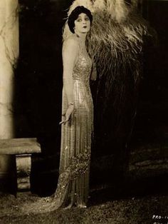 an old photo of a woman in a dress