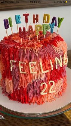 a colorful birthday cake with candles on it that says happy felizing 22 / 2